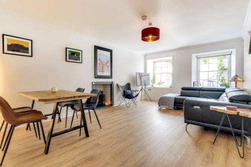 a living room with a couch and a table at Lovely 2 Bedroom Garden Flat in trendy West End in Glasgow