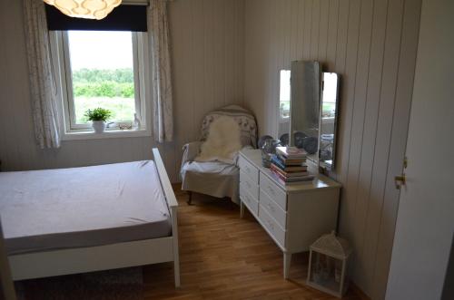 a bedroom with a bed and a dresser and a mirror at Apartament Sandstrand 