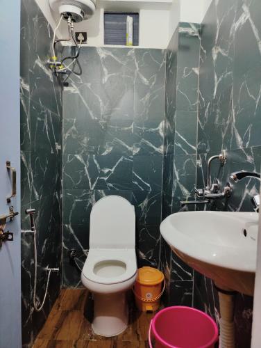 a bathroom with a toilet and a sink at Capt. Mount Stays in Rishīkesh