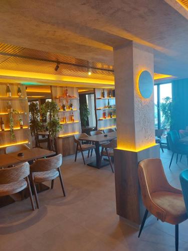 a restaurant with tables and chairs in a room at Milmari Apartments Pahulja N Lux in Kopaonik