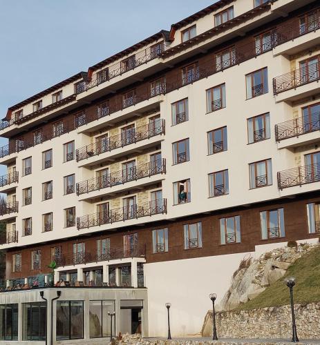 an apartment building with balconies on the side of it at Milmari Apartments Pahulja N Lux in Kopaonik