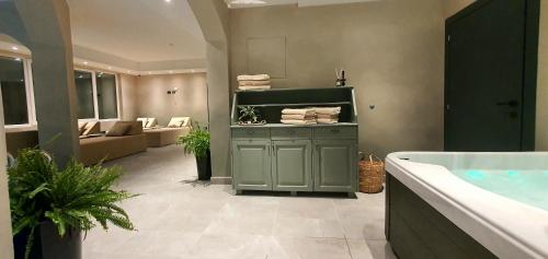 a bathroom with a bath tub and a sink at Boutique Hotel Acacia in Lovran