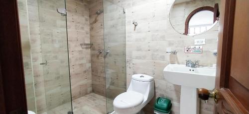 a bathroom with a shower and a toilet and a sink at Hotel Zaraya in Cúcuta