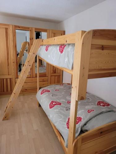 a bedroom with two bunk beds and a staircase at LE CHALET, Superbe Duplex avec Balcon aux Rousses, Netflix, WI-FI, Parking Gratuit et Draps inclus - Animaux Interdits in Les Rousses