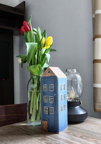 a vase of flowers and a vase of tulips at Apartmány U Aloise in Dolní Morava
