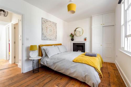 1 dormitorio con 1 cama grande y chimenea en Roof garden house, en Brighton & Hove