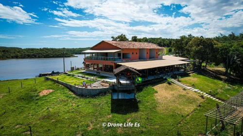 an aerial view of a house on the water at Pousada Peninsula Santa Rita in Guarapari