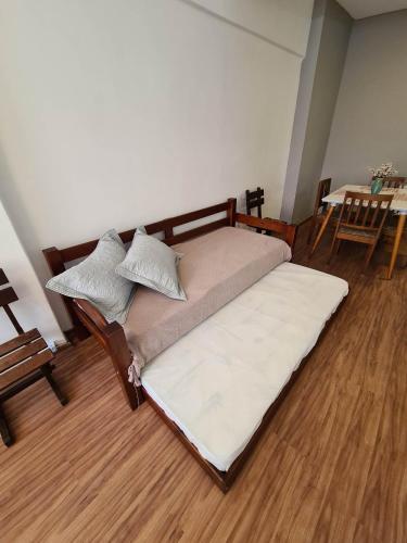 a large bed in a room with a wooden floor at Petrópolis. Centro in Petrópolis
