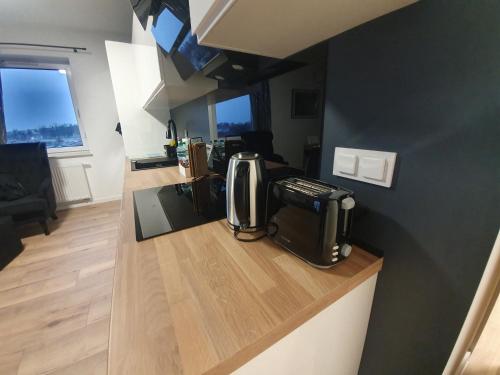 a kitchen with a coffee maker on a counter at Premium Apartaments-Chociszewskiego 6 c in Leszno