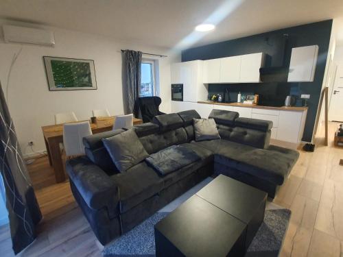a living room with a couch and a table at Premium Apartaments-Chociszewskiego 6 c in Leszno