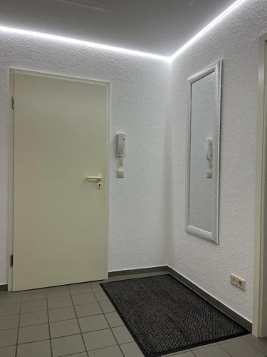 a white door with a mirror in a room at A&D Charmantes Apartment - Bühlertal bei Bühl, Baden-Baden & Schwarzwald in Bühlertal