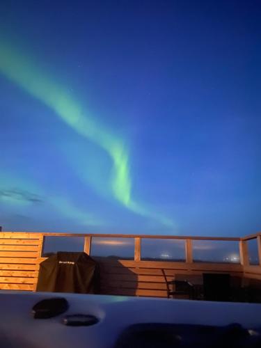 a view of the aurora from the deck of a cruise ship at Hvítuborgir in Minni-Borg