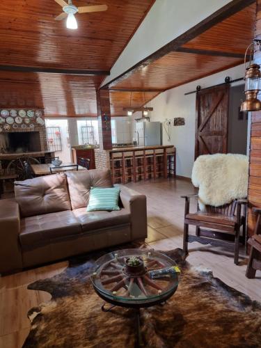 a living room with a couch and a table at Casa do Mato ! Lugar de descanso e Paz !-Next Iguassu Falls in Foz do Iguaçu