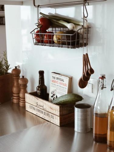 a shelf with vegetables and a book on a kitchen counter at AVLiving City INSIDE NINE Basel in Basel