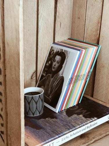 a cup of coffee sitting next to a picture of a woman at AVLiving City INSIDE NINE Basel in Basel
