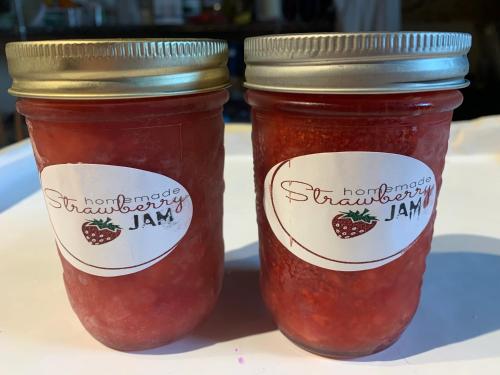 two jars of strawberry jam sitting on a table at Green Oaks B&B in Niagara on the Lake