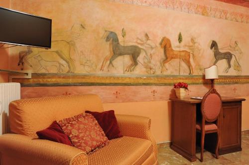 a living room with a couch and a painting of horses at Residenza Cantagalli in Florence