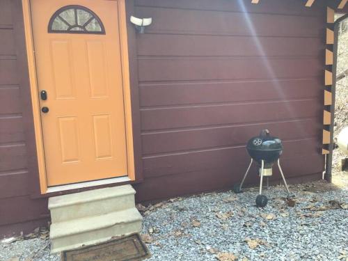 a front door of a house with a bbq grill at Dollywood! Brand new Dancing Bear 3-Bear Tracks in Pigeon Forge