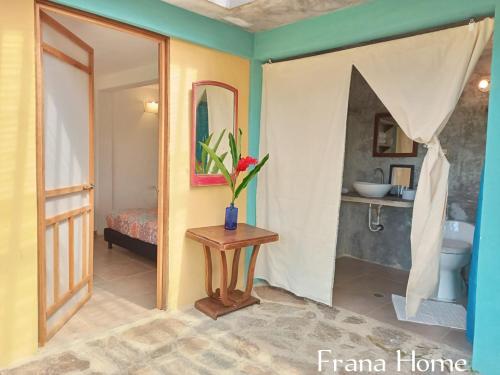 a room with a bathroom with a toilet and a table at Frana Lodge in El Zaino