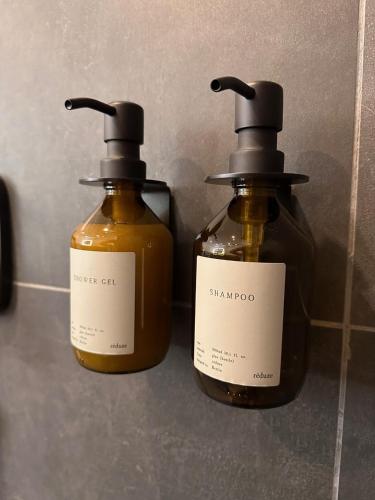 two bottles of soap sitting next to each other at Chalet Schwarz in Berwang