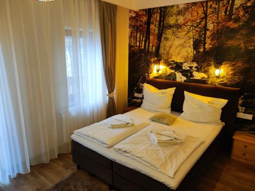 a bedroom with a bed with two glasses on it at Tyrolska Chata in Świeradów-Zdrój