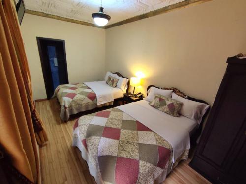 En eller flere senger på et rom på Hotel Vieja Mansion