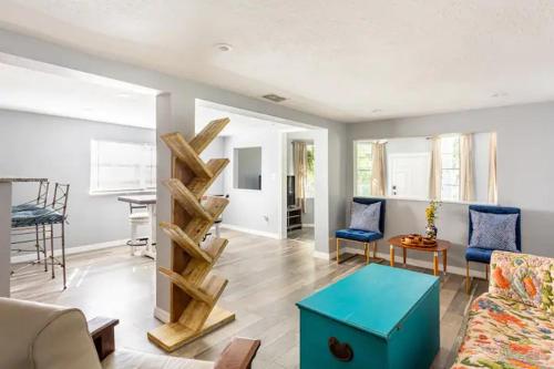 a living room with a blue table in a room at Heights Haven in Tampa