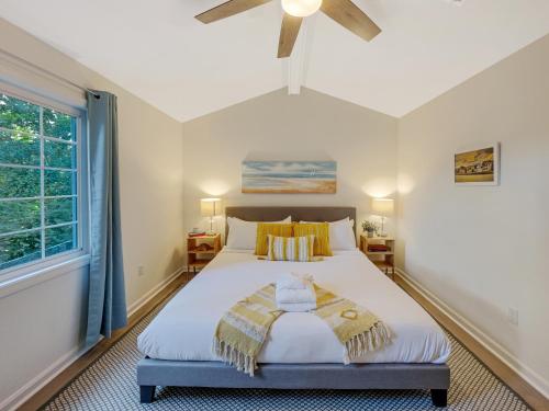a bedroom with a large bed with a ceiling fan at 5 Min to Beach—King Beds in Charleston