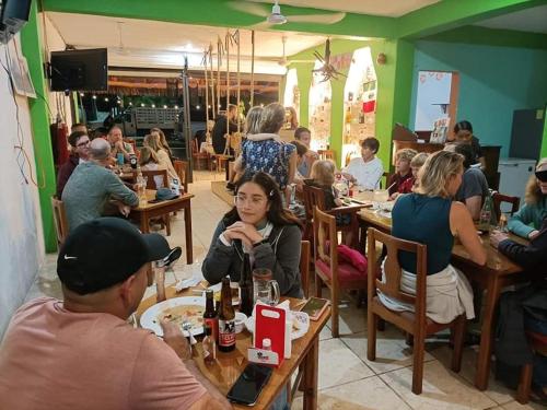a group of people sitting at tables in a restaurant at El Ultimo Maya in Akumal