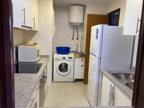 uma cozinha com um frigorífico branco e uma máquina de lavar roupa em Apartamento L'Estartit em L'Estartit