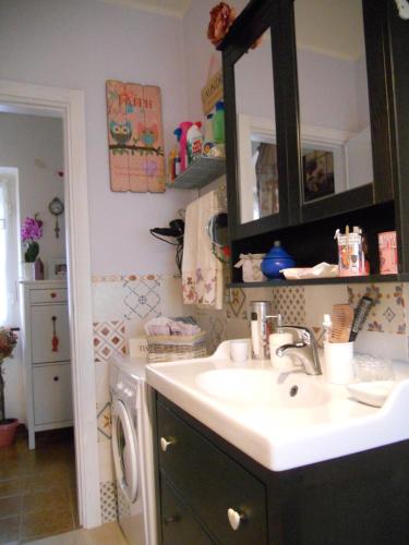 a bathroom with a sink and a washing machine at La casa azzurra in Moneglia