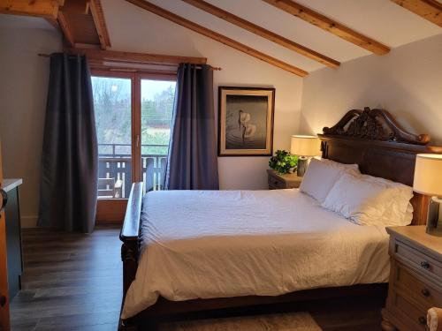 a bedroom with a large bed and a window at Edelweiss Inn Nova Scotia in Middleton