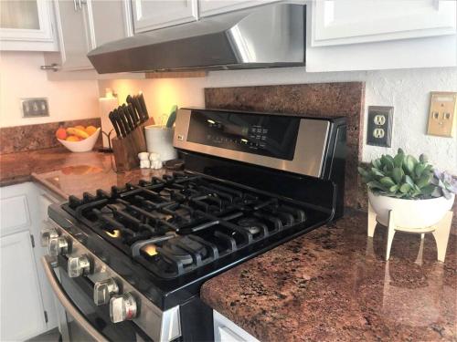 a kitchen with a stove top oven in a kitchen at Upscale Mission Beach Couples Getaway/Pet Friendly in San Diego