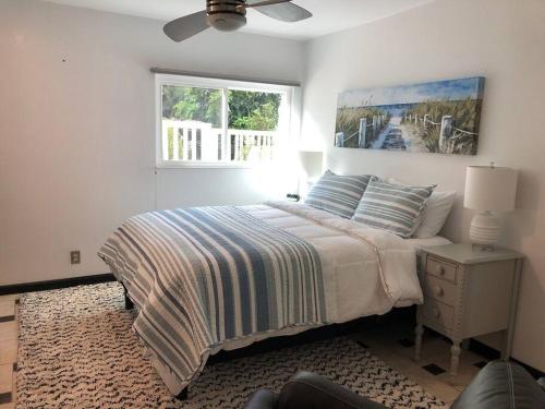 a white bedroom with a bed and a window at Upscale Mission Beach Couples Getaway/Pet Friendly in San Diego
