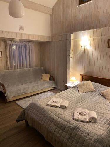 a bedroom with two beds with towels on them at Pensjonat Alpejski Dwór in Miedzygorze