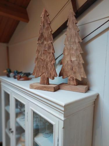 two wooden christmas trees sitting on top of a table at Chalet 172 - La Boverie in Rendeux