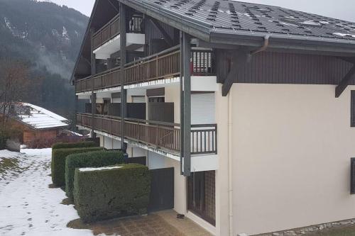 a building with balconies and snow on the ground at Studio agréable in Les Contamines-Montjoie