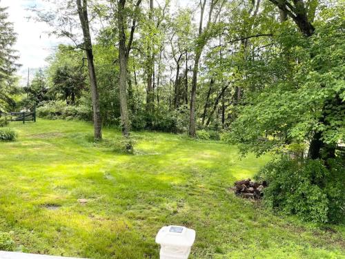 a toilet sitting in the grass in a park at Forest and River Side Tranquil House in Montague