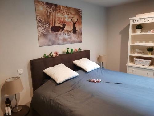 a bedroom with a bed with two pillows on it at lectus IV in Nieuwpoort