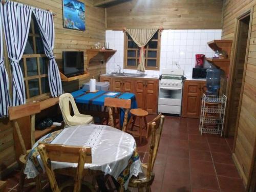 a kitchen with a table and chairs in a room at Chalet in the Woods in Santiago Atitlán