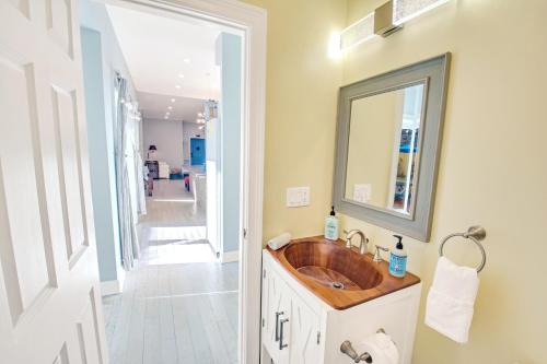 a bathroom with a wooden sink and a hallway at Spacious Oasis - Parking, Private Patio & Roofdeck in Philadelphia