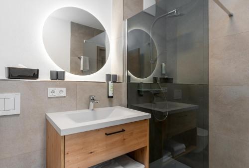 a bathroom with a sink and a mirror at zeitlang by Rösslwirt in Lam