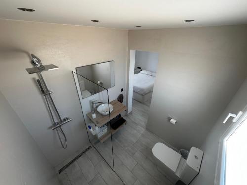 an overhead view of a bathroom with a shower and a toilet at Princesa 202 in Puerto del Carmen