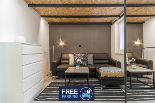 a living room with a couch and a table at Apartments Park Vodice - Ljubljana, Krvavec in Woditz