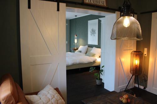 a bedroom with a bed and a room with a mirror at Ferienwohnung GeestZuhause in Heeslingen