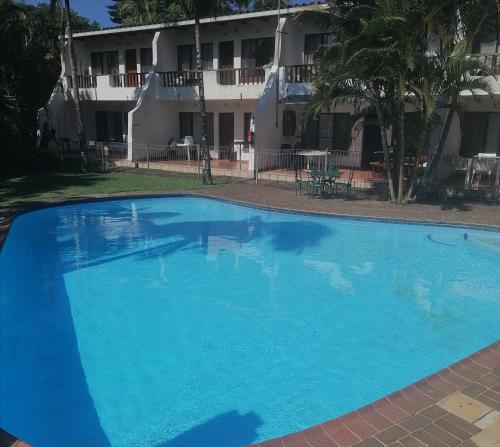 a large blue swimming pool in front of a building at St Lucia Villa Mia 6 in St Lucia