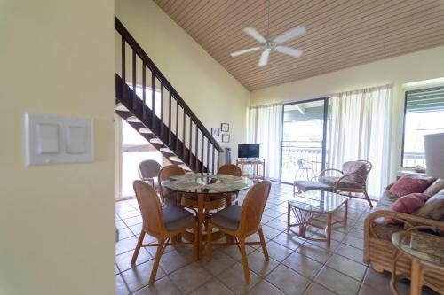 a living room with a table and chairs and a couch at Takanoha Condo in Kahuku