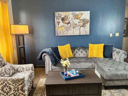 a living room with a couch and a coffee table at Luxury Midtown Flats near Downtown Memphis & FedEx Forum in Memphis