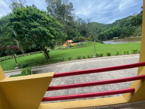 a balcony with a view of a park at Hotel Fazenda Bonanza in Engenheiro Paulo de Frontin