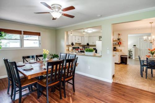 a dining room and kitchen with a table and chairs at {Quiet Suburban Ranch Hot Tub} Mins Arpt/RIT/DWNT in Rochester